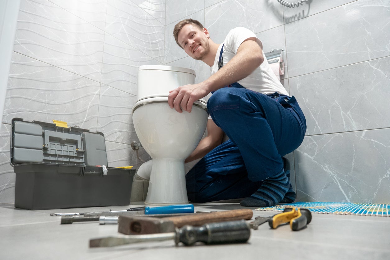 Bathroom Repair Professional plumber repairing leaks in household plumbing.